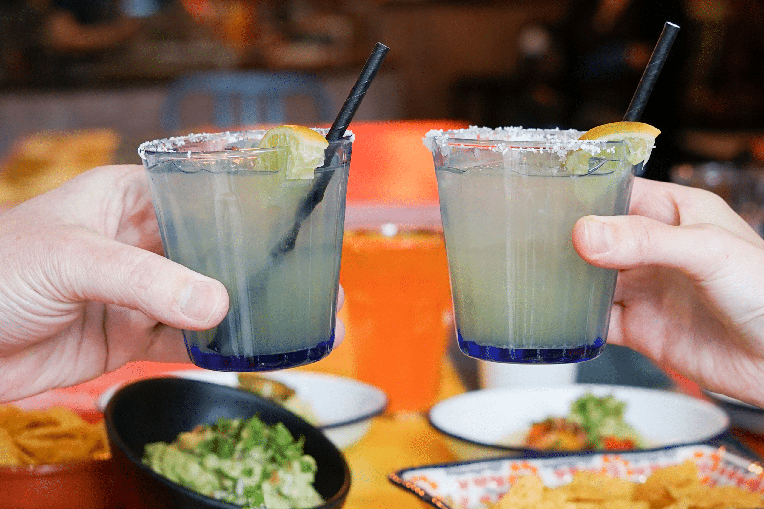 Two people holding a drink